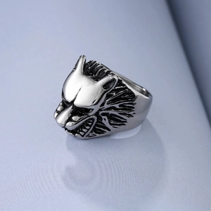 Detailed macro view showing the intricate wolf head carving on a stainless steel ring