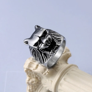 Macro detail of retro stainless steel wolf head ring with intricate fur and fang carvings