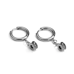 Minimalist stainless steel hoop earrings with engraved cylinder charms on white background