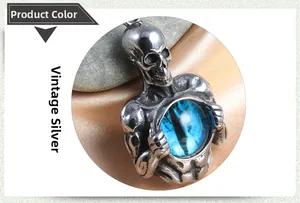 Macro detail of retro silver skull pendant with blue dragon eye stone on silk and pebbles