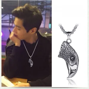 Detailed view of punk style eagle head pendant necklace with vintage steel chain