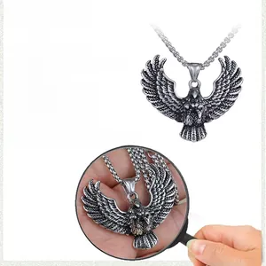 Detail view of retro stainless steel eagle pendant with size specs and feather texture