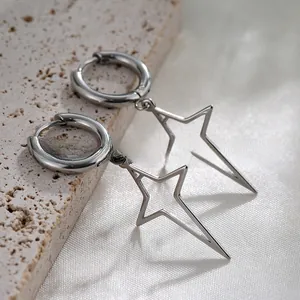 Macro shot of polished silver star pendants on a silk background showing metal texture