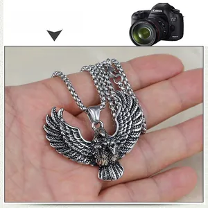 Detailed close-up of retro silver eagle pendant with intricate feather texture on square chain