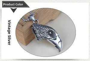 Detailed view of an antique silver eagle head pendant with intricate feather textures