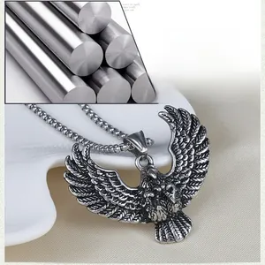 Macro detail of retro eagle pendant with intricate feather textures on steel chain