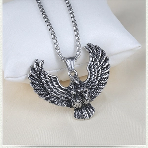 Detailed view of a vintage silver eagle pendant on a box chain for men's necklace