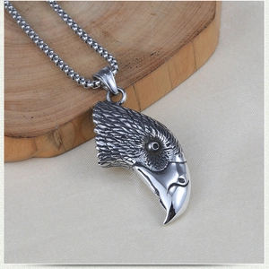 Vintage stainless steel eagle head pendant with detailed carvings on a round bead chain