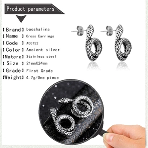 Detailed view of snake-shaped stainless steel earrings in antique silver finish