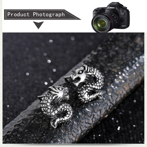 Detailed close-up of dragon shaped steel studs with realistic scales on rock texture
