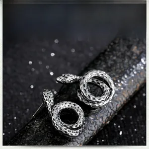 Macro shot of vintage snake earrings showing detailed scale texture in antique silver finish