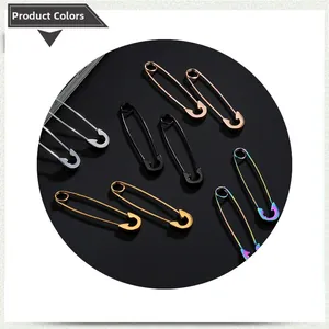 Detailed close-up of safety pin style earrings in silver, gold, black, and rainbow colors