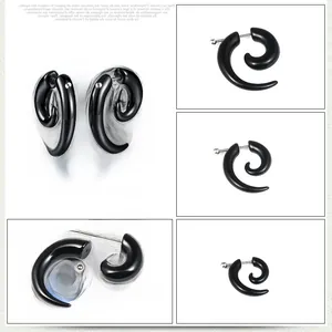 Macro detail of black spiral snail ear studs showing punk style acrylic segmented structure