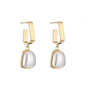 Minimalist geometric gold U-shaped earrings with white translucent pebble pendant