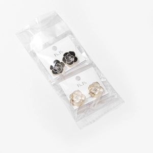 Macro detail of camellia flower stud earrings with 925 silver needles and enamel finish