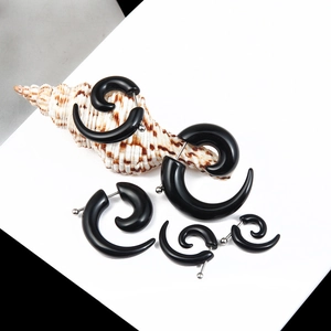 Modern black spiral snail earrings with silver studs displayed on white background