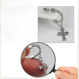 Detail view of vintage silver stainless steel cross drop earrings with size measurements