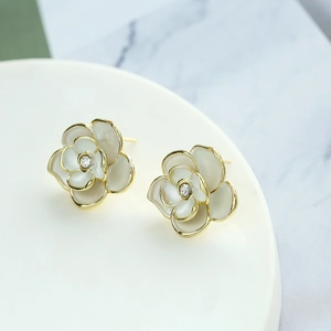 Elegant white enamel camellia flower stud earrings with gold edges and center crystal