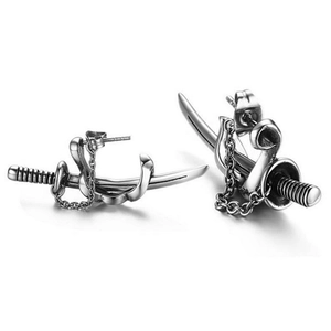 Close-up of gothic sword stud earrings with thin chains and antique silver finish