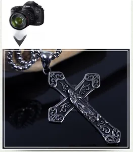 Macro view of vintage stainless steel hollow cross pendant with baroque carvings