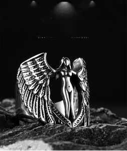 Macro view of vintage silver archangel wing ring with heart-shaped angel emblem