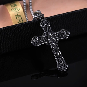 Macro detail of retro stainless steel hollow cross necklace with Virgin Mary relief