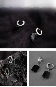 Close-up of stainless steel earrings featuring black geometric octagonal pendants