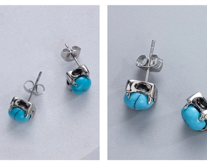 Macro view of vintage silver steel stud earring featuring a turquoise bead inlay
