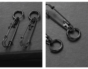 Detail of black safety pin earrings with cross charms made of durable stainless steel