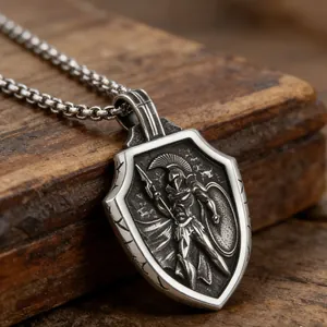 Macro view of vintage silver Spartan warrior relief on stainless steel shield pendant