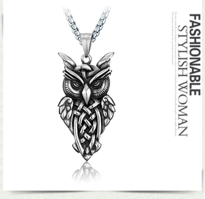 Detail of vintage owl pendant with intricate Celtic knot patterns on a square chain link