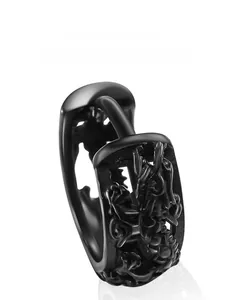 Close-up of black titanium steel hoop earring with industrial embossed relief texture