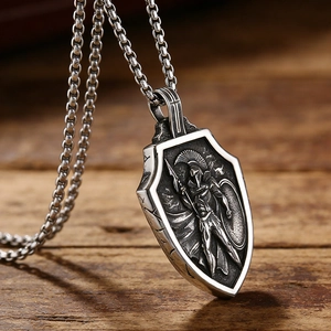 Macro shot of stainless steel Spartan shield pendant with vintage embossed warrior detailing