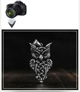 Macro shot of owl pendant showing intricate celtic patterns and vintage steel texture