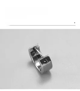Macro shot of vintage huggie earring in dark silver finish with a black center stone
