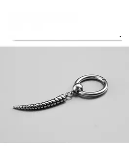 Close-up of stainless steel hoop earring with punk style spiral cone pendant detail