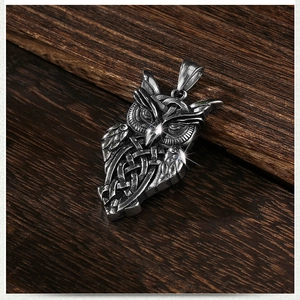 Retro stainless steel owl pendant necklace with Celtic knot patterns on wood background