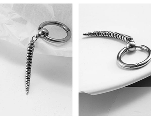 Close-up of stainless steel hoop earring with spiral drop pendant and bead detail