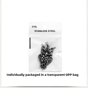 Detail view of a retro 316L stainless steel owl pendant in single OPP bag packaging