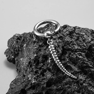 Minimalist stainless steel cross hoop earring on black volcanic rock for men and women