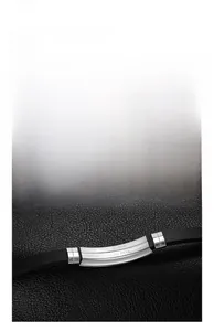Detail shot of the stainless steel metal plate with clear engraving on black silicone strap