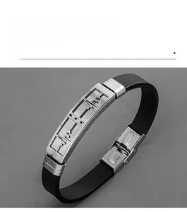 Close-up of stainless steel plate with engraved heartbeat motif on black silicone band