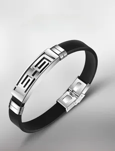 Detail of black silicone sports bracelet showing hollowed metal plate and stainless steel buckle