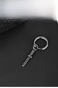 Detailed view of a punk style stainless steel sword drop earring on black texture