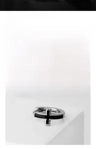 Detail of silver square cross earrings with black enamel inlay and polished steel finish