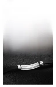 Close-up of black silicone wristband with brushed stainless steel metal plate detail