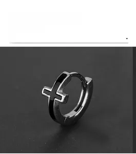 Close-up of a silver stainless steel hoop earring with a black inlaid cross design