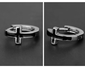 Detail of silver stainless steel hoop earrings with black enamel cross pattern design