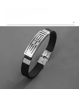 Macro detail of men's stainless steel bracelet with geometric Greek key patterns