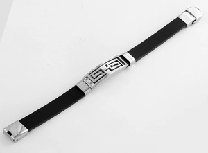 Detail of men's black silicone bracelet with silver hollow geometric maze pattern